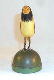 2008 Hand Carved Polychrome Painted Wooden Primitive Folk Art Yellow and Black Colored Bird Wire Legs Green Base By Jonathan Bastian