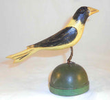 2008 Hand Carved Polychrome Painted Wooden Primitive Folk Art Yellow and Black Colored Bird Wire Legs Green Base By Jonathan Bastian